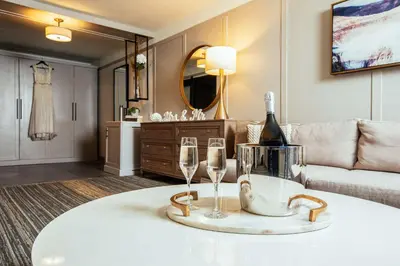 a room with a table with wine glasses and a couch at Somerset Hills Hotel, Tapestry Collection by Hilton in Basking Ridge