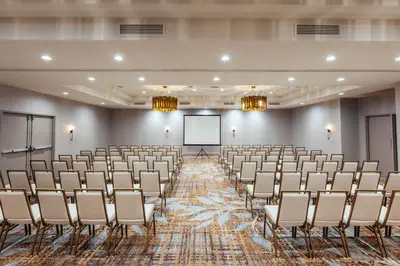 an empty room with chairs and a projection screen at Somerset Hills Hotel, Tapestry Collection by Hilton in Basking Ridge