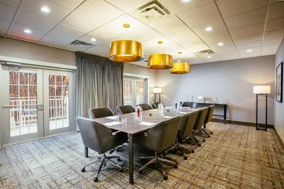 a conference room with a long table and chairs at Somerset Hills Hotel, Tapestry Collection by Hilton in Basking Ridge