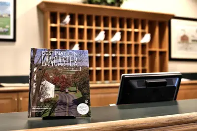 a book sitting on a table next to a computer at Lancaster Inn & Suites in Manheim