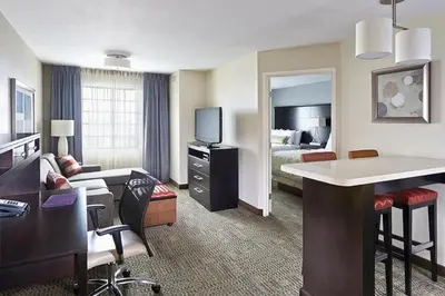 a hotel room with a bed and a living room at Staybridge Suites Montgomeryville by IHG in North Wales