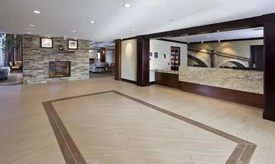 a lobby with a fireplace and a living room at Staybridge Suites Montgomeryville by IHG in North Wales
