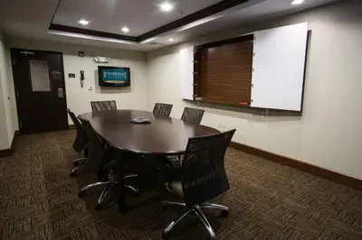 a conference room with a wooden table and chairs at Staybridge Suites Montgomeryville by IHG in North Wales