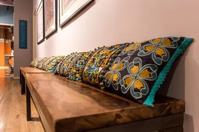 a row of pillows sitting on a wooden bench at Sanctuary NYC Retreats in New York