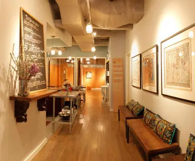 a hallway with chairs and a table in a building at Sanctuary NYC Retreats in New York