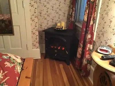 a living room with a fireplace in a room at Brookview Manor Inn in Canadensis