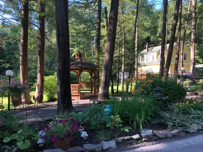 a gazebo in the middle of a garden at Brookview Manor Inn in Canadensis