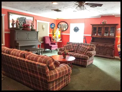 a living room with two couches and a piano at Days Inn by Wyndham Tannersville in Tannersville