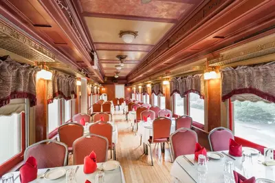 a dining car of a train with tables and chairs at Days Inn by Wyndham Tannersville in Tannersville