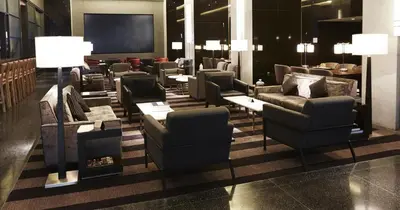 a waiting room with couches and chairs in a building at Loews Philadelphia Hotel in Philadelphia