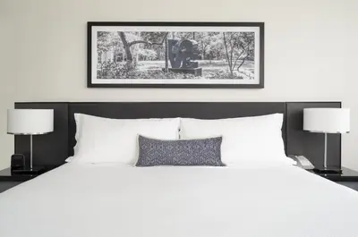 a bedroom with a large white bed with two lamps at Loews Philadelphia Hotel in Philadelphia