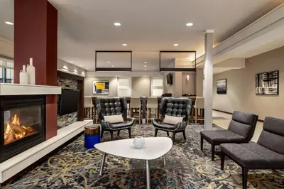 a waiting room with chairs and a fireplace at Residence Inn by Marriott Williamsport in Williamsport