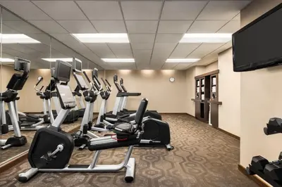 a gym with tread machines and a flat screen tv at Residence Inn by Marriott Williamsport in Williamsport