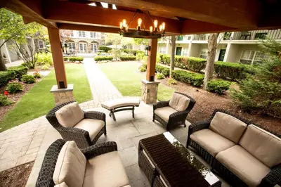 a patio with couches and chairs and a table at The Olde Mill Inn Basking Ridge in Basking Ridge