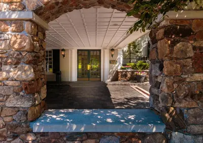 an entrance to a building with a stone wall at The Olde Mill Inn Basking Ridge in Basking Ridge