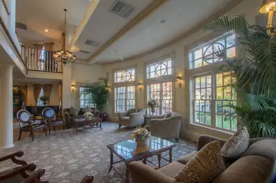 a large living room with couches and a table at The Olde Mill Inn Basking Ridge in Basking Ridge
