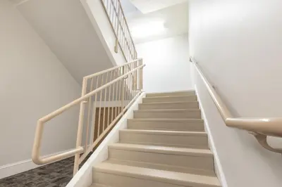 a staircase in a house with white walls and white stairs at Selinsgrove Inn in Selinsgrove