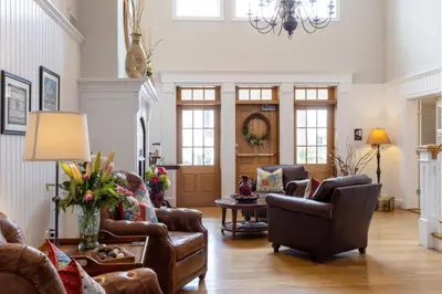 a living room with leather furniture and a chandelier at Selinsgrove Inn in Selinsgrove