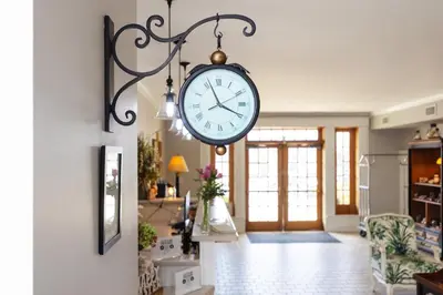 a clock hanging from a wall in a living room at Selinsgrove Inn in Selinsgrove
