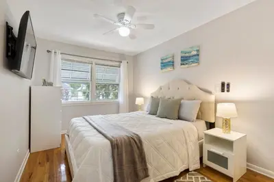 a bedroom with a bed and a ceiling fan at Close to NYC | King Bed | Free Parking in Bloomfield