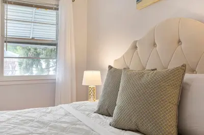 a bedroom with a white bed with a window at Close to NYC | King Bed | Free Parking in Bloomfield