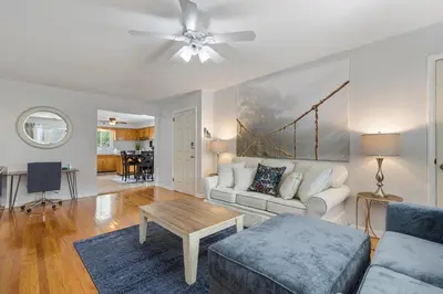 a living room with a couch and a table at Close to NYC | King Bed | Free Parking in Bloomfield