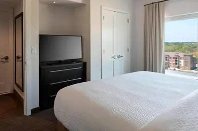a bedroom with a bed and a flat screen tv at Residence Inn by Marriott Lancaster in Lancaster