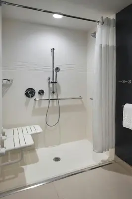 a white bathroom with a shower with a shower curtain at Residence Inn by Marriott Lancaster in Lancaster