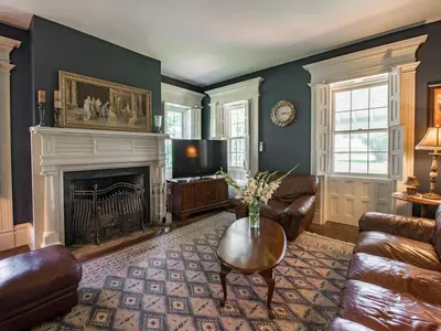 a living room with a couch and a fireplace at The Neighbour House B&B in Long Valley