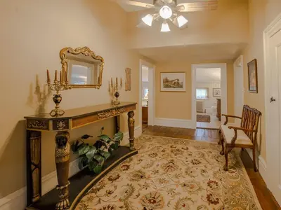 a living room with a fireplace and a mirror at The Neighbour House B&B in Long Valley