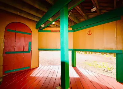 an inside view of a building with a red and green door at ⛰⛵️⛱Mt. Maplewood Lodge❤️Seasonal Specials ☆Poconos☆Cabin☆Hot⛷Tub☆Game Room☆ in Pocono Pines