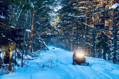 a person riding a snowmobile down a snow covered road at ⛰⛵️⛱Mt. Maplewood Lodge❤️Seasonal Specials ☆Poconos☆Cabin☆Hot⛷Tub☆Game Room☆ in Pocono Pines