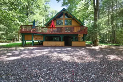 a large house in the middle of a forest at ⛰⛵️⛱Mt. Maplewood Lodge❤️Seasonal Specials ☆Poconos☆Cabin☆Hot⛷Tub☆Game Room☆ in Pocono Pines