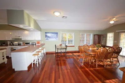 a kitchen and dining room with a table and chairs at Mt. Maplewood Chalet in Pocono Lake