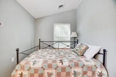 a bedroom with a bed with a quilt on it at Mt. Maplewood Chalet in Pocono Lake