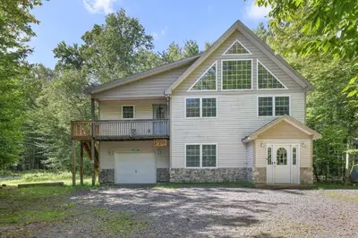 a large white house with a gambrel at Mt. Maplewood Chalet in Pocono Lake