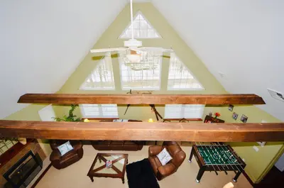 an overhead view of a loft with a table and chairs at Mt. Maplewood Split Chalet in Pocono Lake