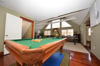a living room with a pool table in it at Mt. Maplewood Split Chalet in Pocono Lake