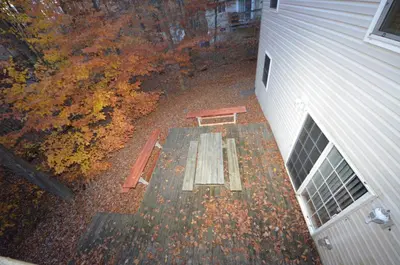 an overhead view of a bench on a patio next to a building at Mt. Maplewood Split Chalet in Pocono Lake