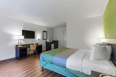 a hotel room with a bed and a desk at Motel 6-Warminster, PA in Warminster