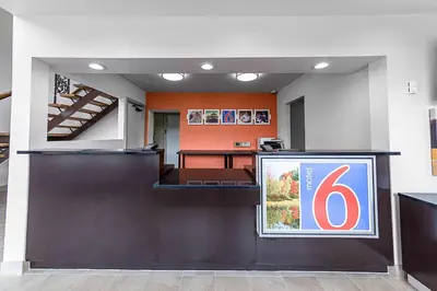 an office with a desk and a sign on the wall at Motel 6-Warminster, PA in Warminster