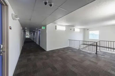 an empty hallway of an office building with stairs at Motel 6-Warminster, PA in Warminster