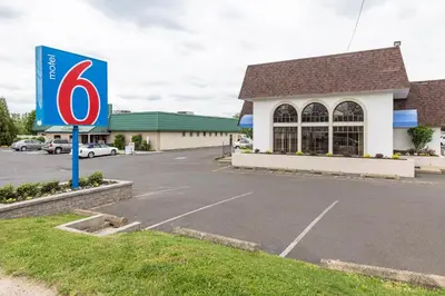 a sign in a parking lot in front of a store at Motel 6-Warminster, PA in Warminster