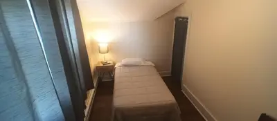a small room with a small bed in a room at Cappuccio Hotel in Keansburg