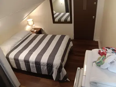 a hotel room with two beds and a mirror at Cappuccio Hotel in Keansburg