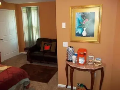 a room with a bed and a table with a couch at Tin Brook Bed & Breakfast in Walden