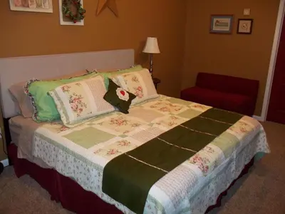 a bedroom with a large bed with pillows at Tin Brook Bed & Breakfast in Walden