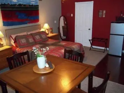 a bedroom with a bed and a table with a remote control at Tin Brook Bed & Breakfast in Walden