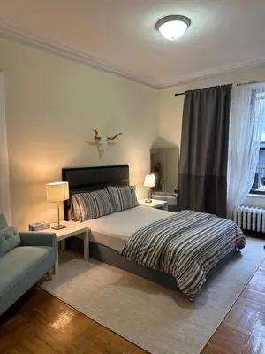 a bedroom with a bed and a bird on the wall at TIME SQUARE 42nd Street Private Room in New York