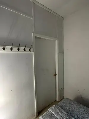 a room with a closet with a door and a bed at TIME SQUARE 42nd Street Private Room in New York